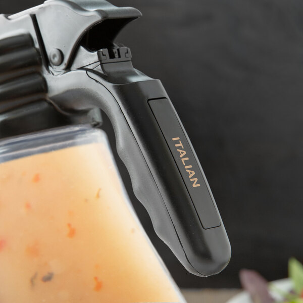 A Tablecraft black plastic container with an orange "Italian" label filled with liquid.
