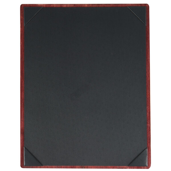 A black board with a wooden frame and red corners on a table.