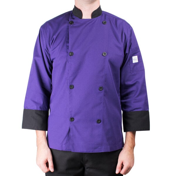 A person wearing a Mercer Culinary purple chef coat.