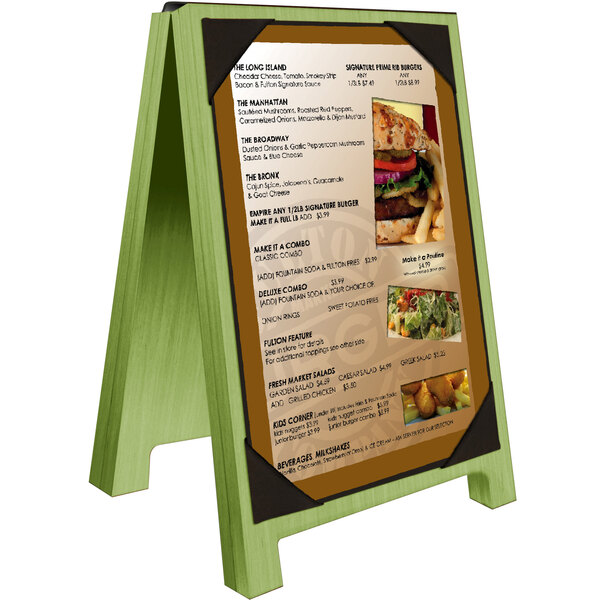 A Menu Solutions lime wood menu board tent with picture corners on a table with a burger.