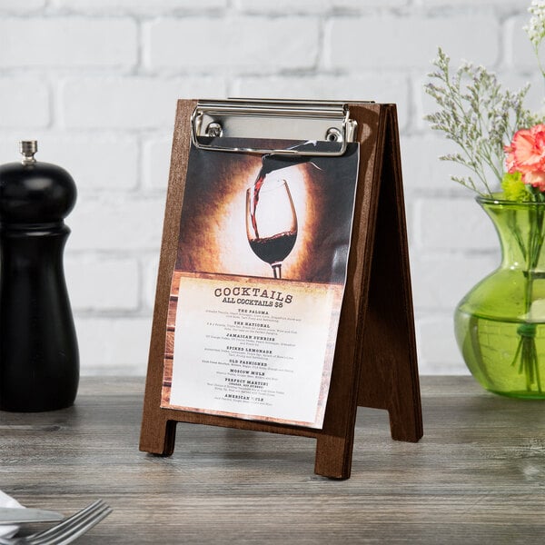 A walnut wood Menu Solutions sandwich board tent with a menu on it.