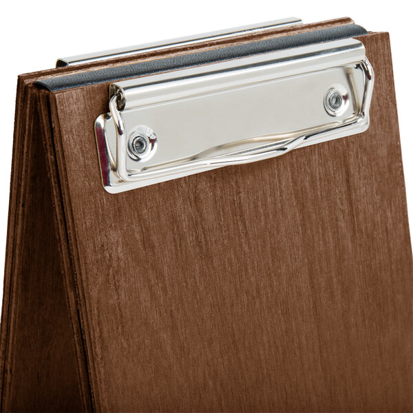A walnut wood clipboard menu tent with a metal clip.