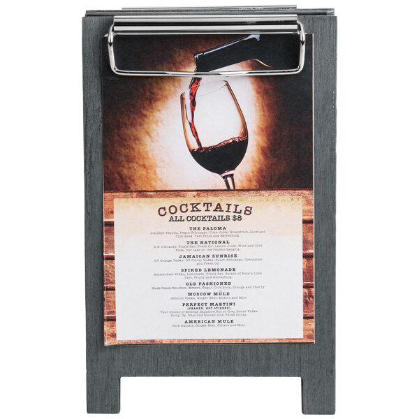 A Menu Solutions ash wood sandwich menu board tent with a clip on a table displaying a menu.