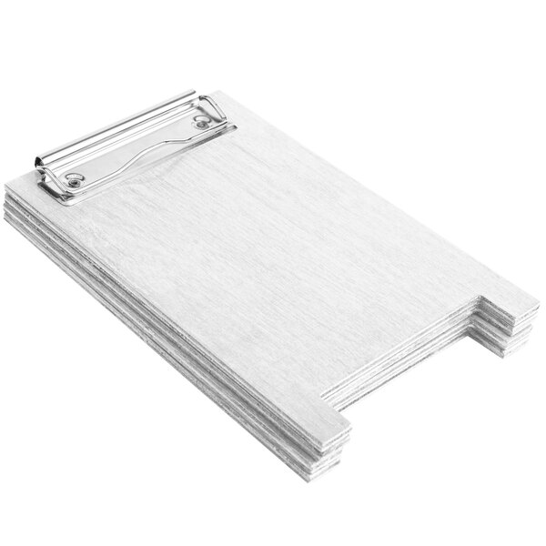 A stack of white wood sandwich menu boards with a metal clip.