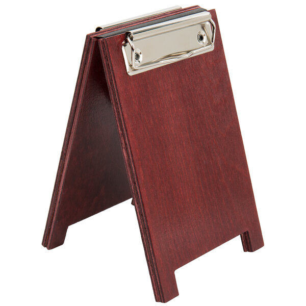 A mahogany wood menu tent with a silver metal clip.