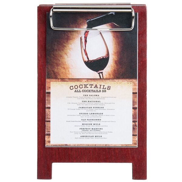 A Mahogany wood menu tent with a clip on a table holding a menu.
