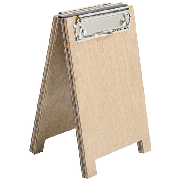 A wooden Menu Solutions sandwich menu board tent with a metal clip.