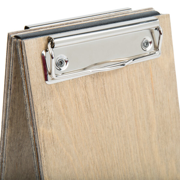 A wood menu board tent with a metal clip.