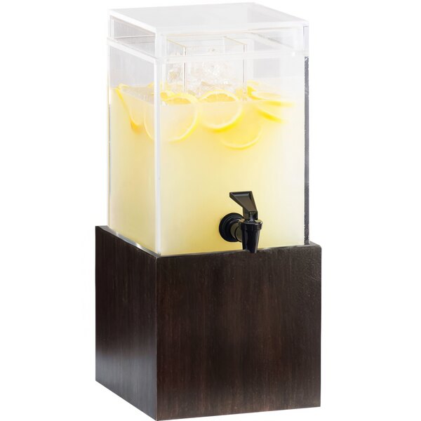 A Cal-Mil bamboo beverage dispenser with lemon water and lemons.