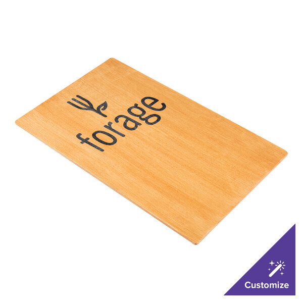 A Menu Solutions customizable wood menu board with picture corners on a table with a wood sign with black text.