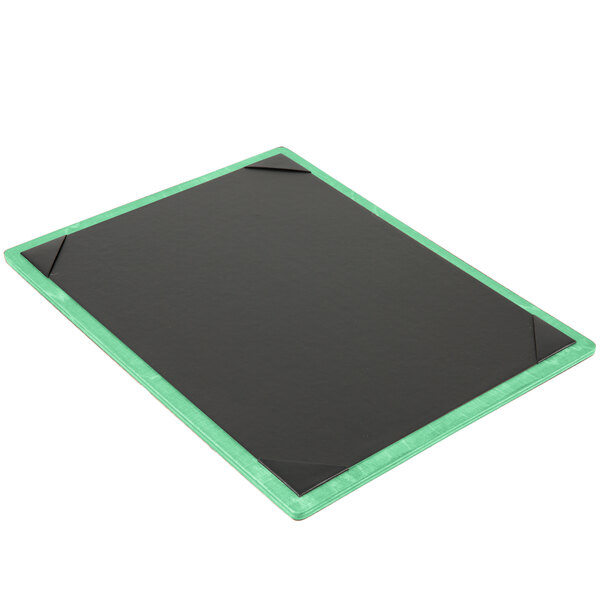 A black menu board with a green border on a table.
