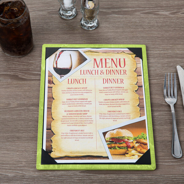 A Menu Solutions wood menu board with picture corners on a table with a menu featuring a picture of a meal.