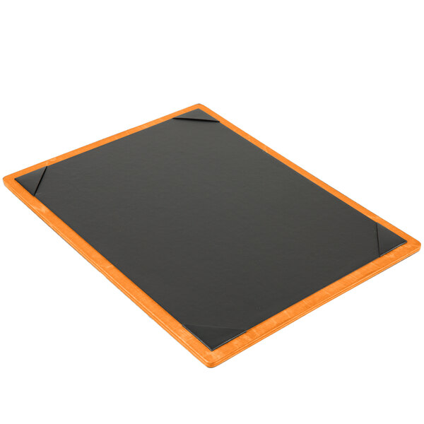 A black wood menu board with orange trim on a table.