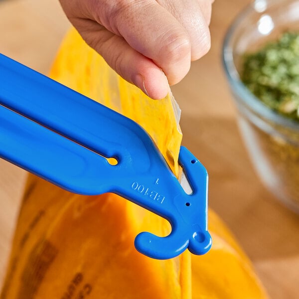 A close-up of a hand using a blue plastic tool to squeeze and cut open a yellow plastic bag.