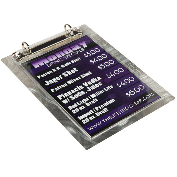 A Menu Solutions Alumitique aluminum menu board with swirl finish and two rings holding a menu.