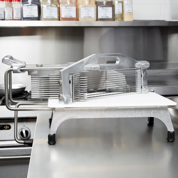 A Vollrath Tomato Pro 1/4" Tomato Slicer on a kitchen counter.