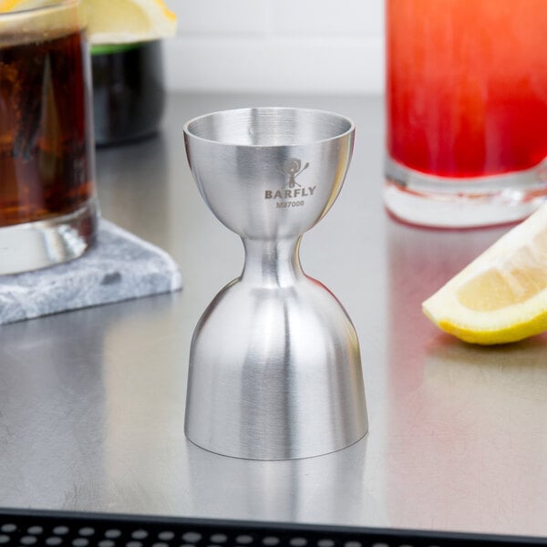 A Barfly stainless steel heavy-duty straight rim bell jigger on a counter.