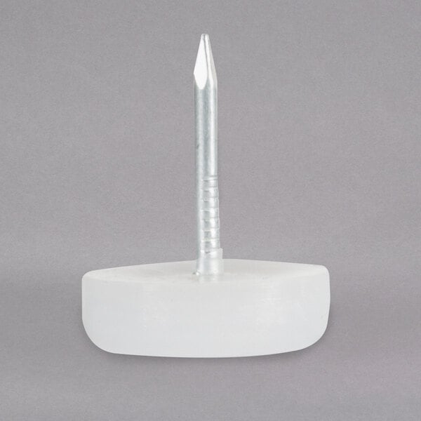 A white plastic chair and bar stool glide with a metal nail.