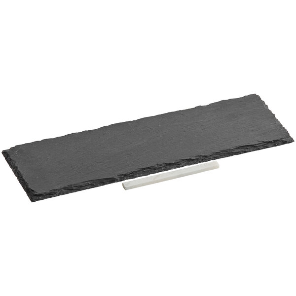 A rectangular black slate tray with a white soapstone stick on a white base.