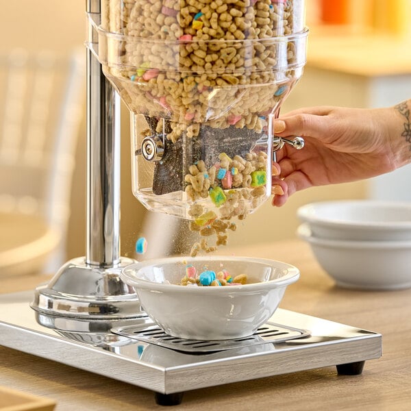 A double canister cereal dispenser dispensing cereal into a white bowl.