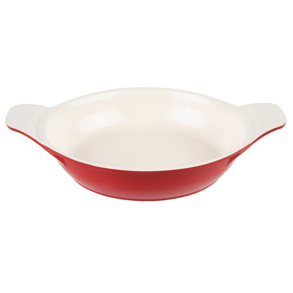 A red and white enamel coated cast aluminum round pan.