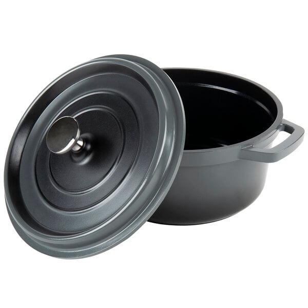 A gray enamel coated cast aluminum round Dutch oven with a lid on the handle.