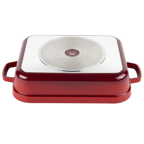 A red and white rectangular roasting pan with a lid.
