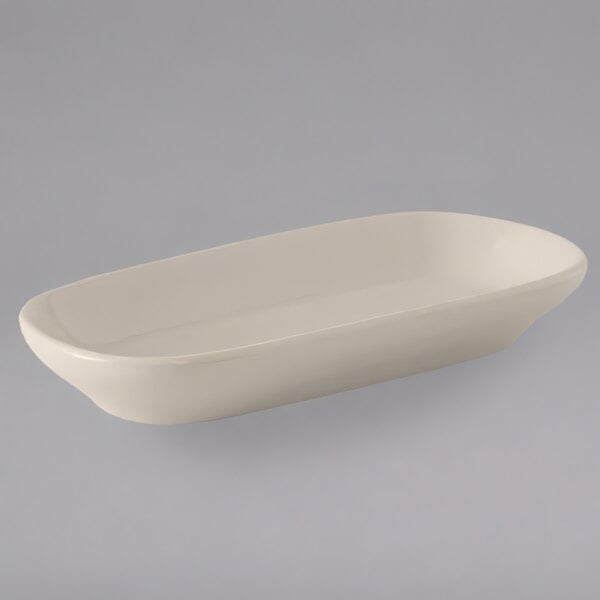 A white rectangular Tuxton eggshell china relish tray.