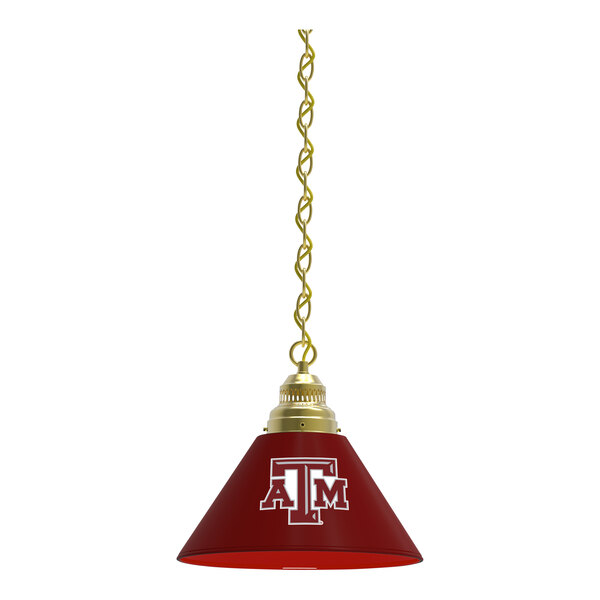A red lamp shade with a Texas A&M logo on it hanging from a brass chain.