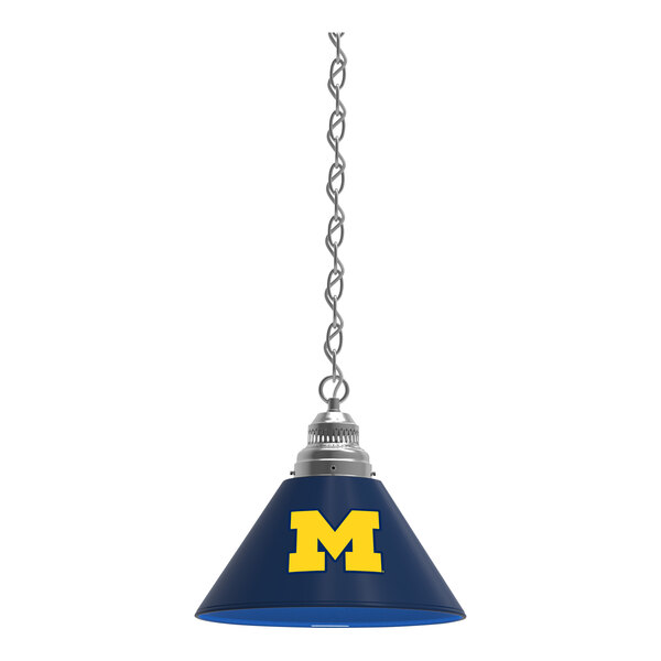 A blue lamp shade with a yellow letter M on it.