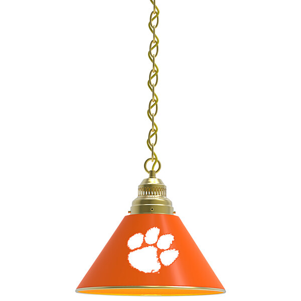 A brass pendant light with an orange Clemson University paw print.