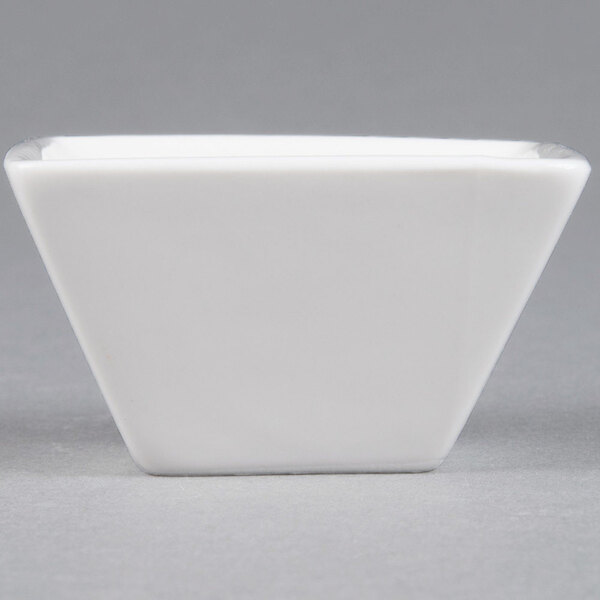 An American Metalcraft white square porcelain sauce cup.