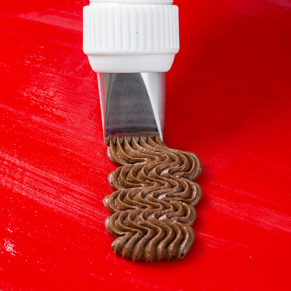 A white plastic pastry bag with brown basketweave frosting on the end.