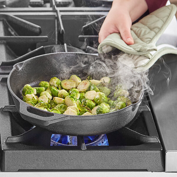 Brussel sprouts being cooked in a cast iron skillet