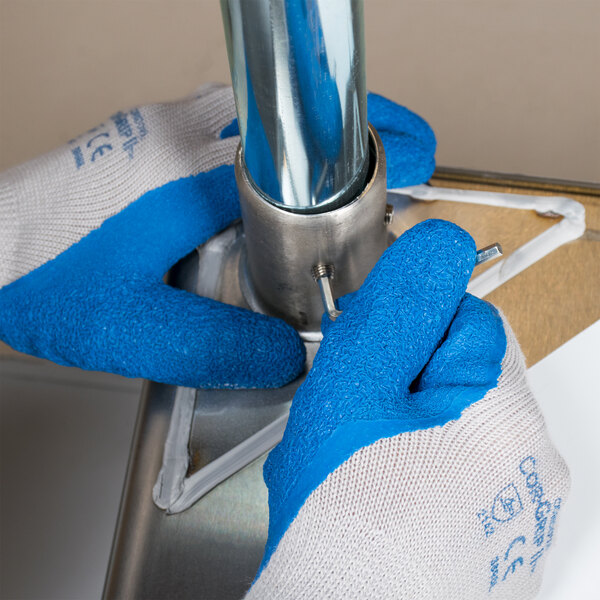 Cordova Cor-Grip blue latex gloves holding a metal pole.