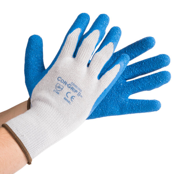 A person wearing Cordova Cor-Grip gloves with blue latex coating on the palms.