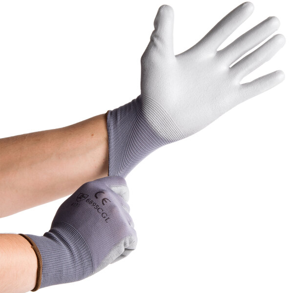 A pair of Cordova gray and white warehouse gloves.