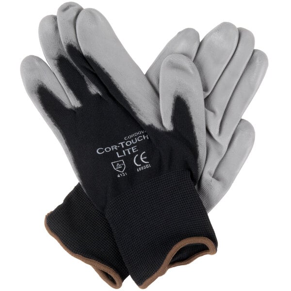 A pair of Cordova black nylon gloves with gray palm coating on a white background.