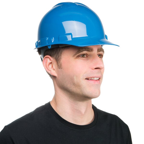 A man wearing a Cordova blue cap style hard hat.