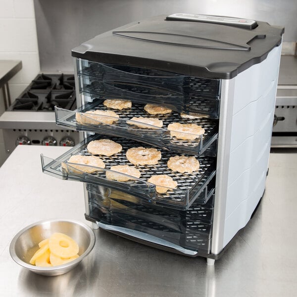 Food on trays inside a Weston food dehydrator.