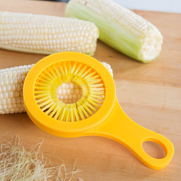 A yellow Weston Desilker corn brush with a hole in the center.