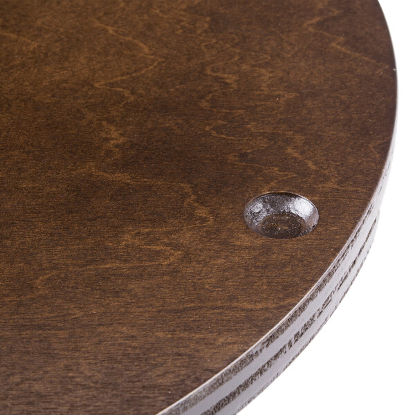 A close up of a Bon Chef mahogany lazy susan on a table.