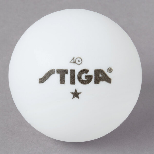 A white Stiga ping pong ball with black text on it.