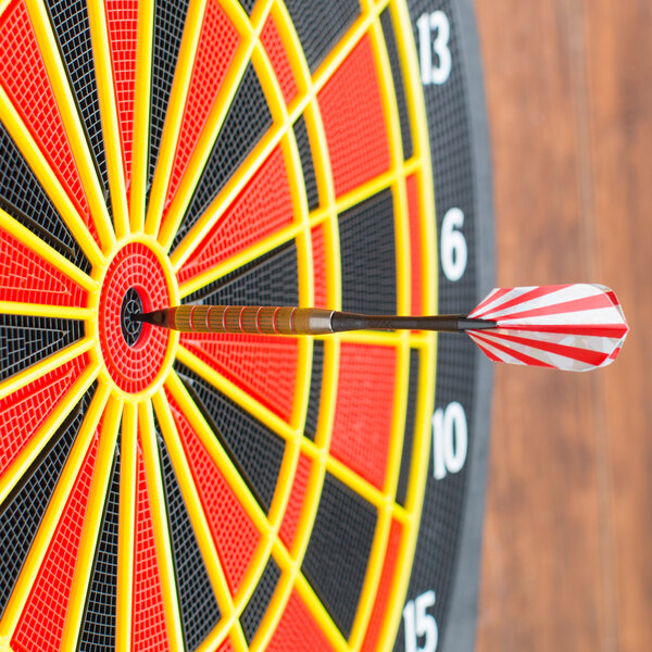 A black Arachnid striped soft tip dart in the center of a dart board.
