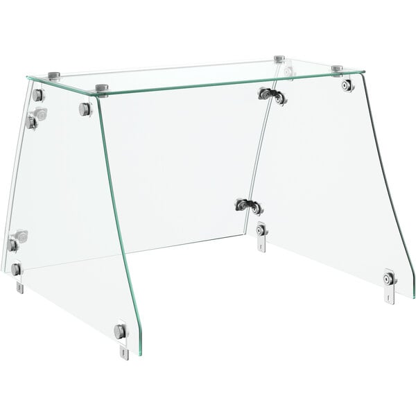 An Avantco flat glass sneeze guard with metal hinges over a table.
