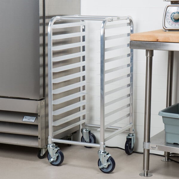 An unassembled aluminum Regency steam table pan rack with wheels.