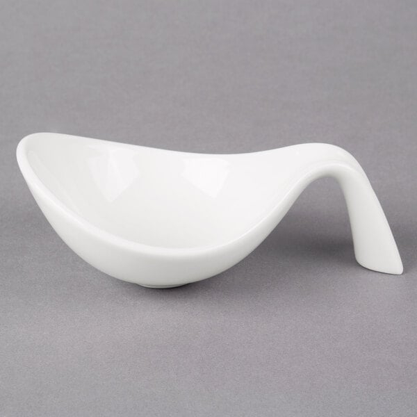 A Villeroy & Boch white porcelain bowl with a curved handle.
