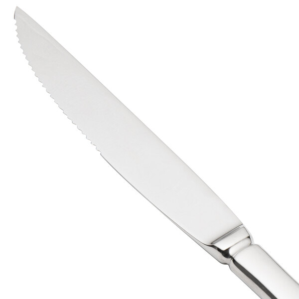 A close-up of a Walco Lancer stainless steel steak knife with a solid handle.