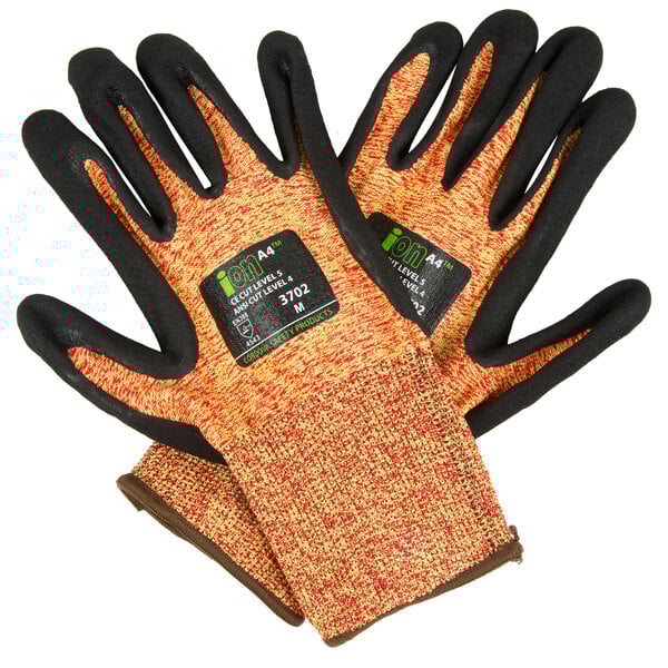 A pair of Cordova cut resistant gloves with orange, black, and sandy nitrile accents on a white background.