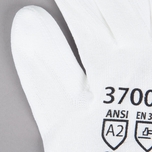 A pair of extra large Cordova white gloves with white polyurethane palms.